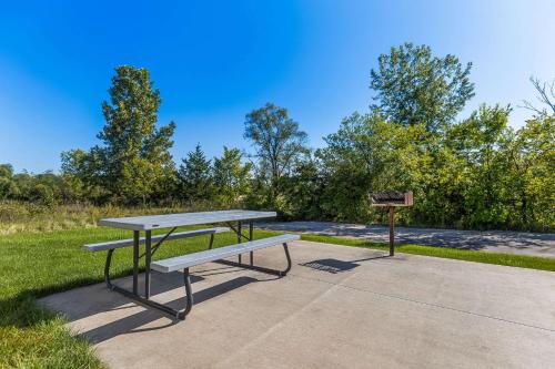 a picnic table and a grill in a park at Quality Inn Oskaloosa in Oskaloosa