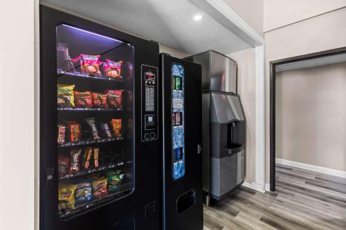 a black refrigerator with food and drinks in a room at Quality Inn Oskaloosa in Oskaloosa