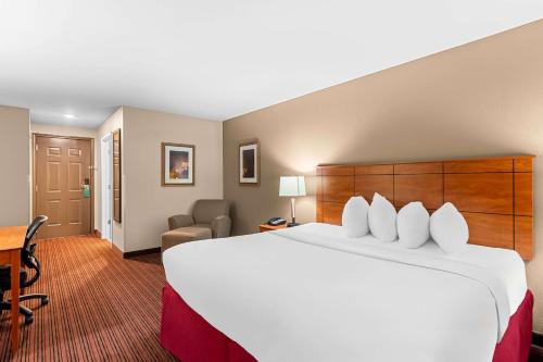a hotel room with a large bed and a desk at Quality Inn in Blackwell
