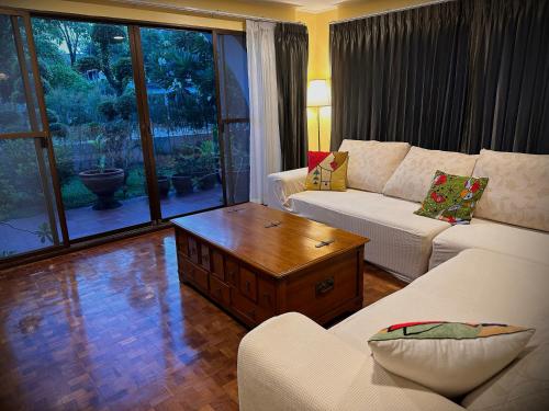 a living room with a couch and a coffee table at Newly-renovated Modern Private Thai Villa with Swimming Pool in Ban Khlong Samrong