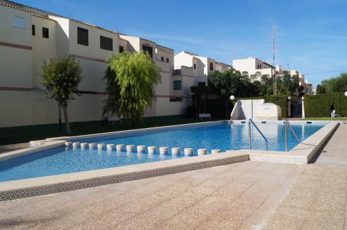 a swimming pool in front of a building at ESPAGNE - ALICANTE - GUARDAMAR DEL SEGURA in Guardamar del Segura