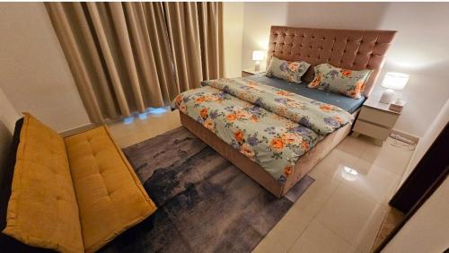 a bedroom with a bed with a floral bedspread at Deluxe Villa Rooms near Dubai Airport in Dubai
