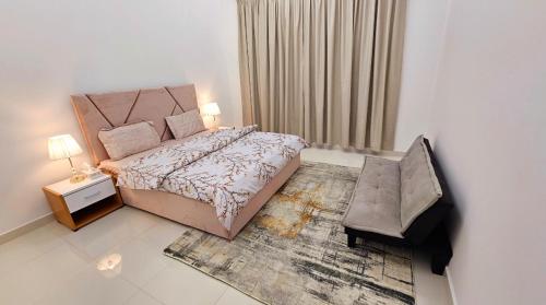 a bedroom with a large bed and a chair at Deluxe Villa Rooms near Dubai Airport in Dubai