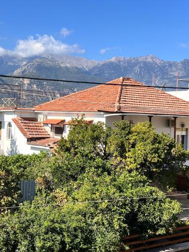a white building with a red roof and some trees at The Captain's Nest in Sparti