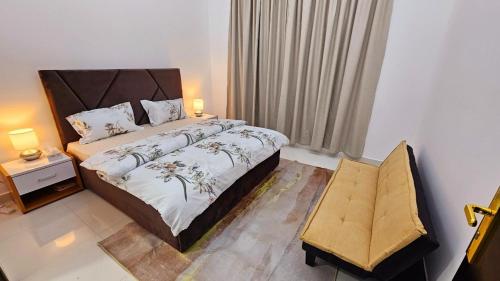 a bedroom with a large bed and a chair at Elegant Villa Rooms in Dubai near Airport in Dubai