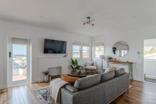 a living room with a couch and a tv at Burnie Retreat - Coastal Comfort Awaits in Burnie