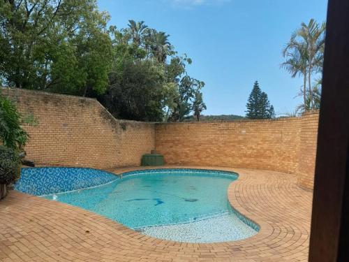 a brick wall and a swimming pool in a brick yard at Buffalo View Lodge in East London
