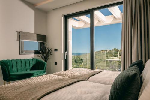 a bedroom with a bed and a large window at Villa Vatia 3 in Tragaki