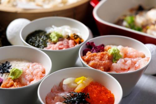 a group of bowls filled with different types of food at Hakone Kowakien Hotel in Hakone