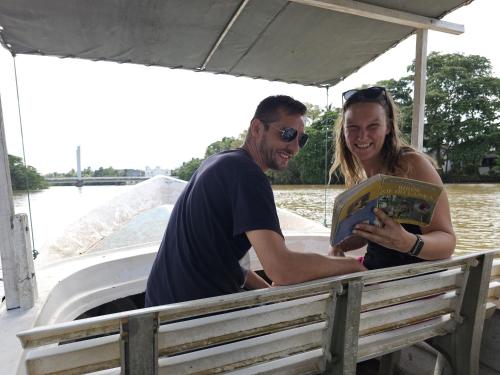 a man and woman on a boat looking at a book at Hanguk Villa Mirissa in Mirissa