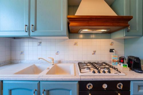 a kitchen with a sink and a stove top oven at Spring Apartment by Wonderful Italy in Como