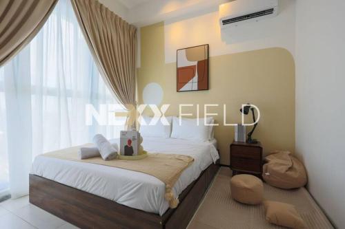 a bedroom with a bed and a large window at Urban Suites Penang by Nexx Field in Jelutong