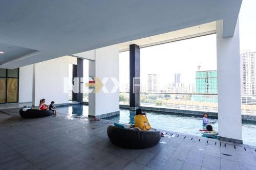 a group of people sitting in bean bags in a building at Urban Suites Penang by Nexx Field in Jelutong