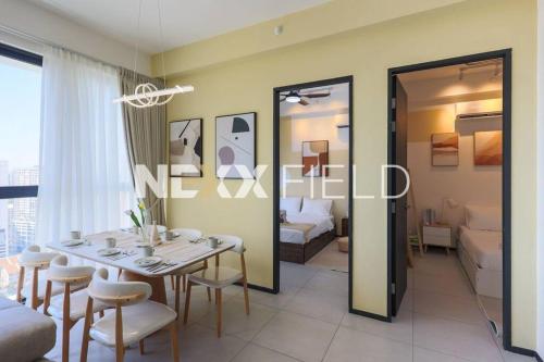 a dining room with a table and chairs and a bedroom at Urban Suites Penang by Nexx Field in Jelutong