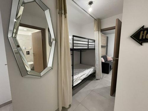 Ce dortoir comprend un miroir et des lits superposés. dans l'établissement Charmant studio au cœur du centre-ville, à Calvi
