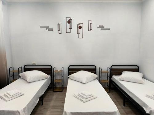two beds in a room with a wall at Alyona's house in Vagharshapat