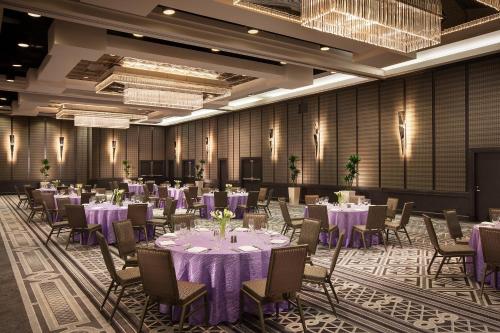 a banquet hall with purple tables and chairs at Sheraton Grand Los Angeles in Los Angeles