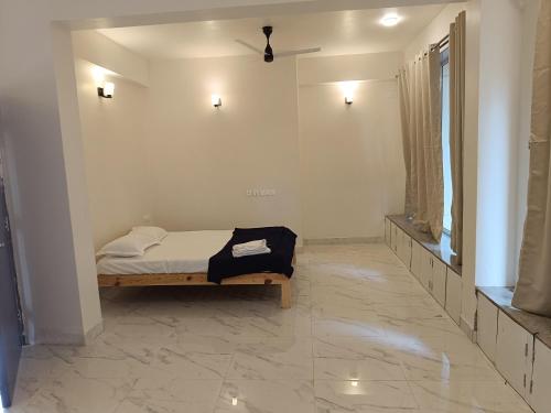a bedroom with a bed and a mirror at Ecoark Farmstay in Cuncolim