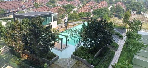 an aerial view of a house with a swimming pool and trees at HABITUS Elmina Denai Alam in Shah Alam