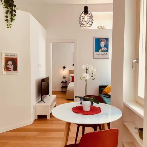 a living room with a table and a room with a bed at City center, all around you in Turin