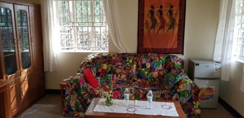 a living room with a couch and a table at Mutolere Coffee Pot Guest Houses in Kisoro
