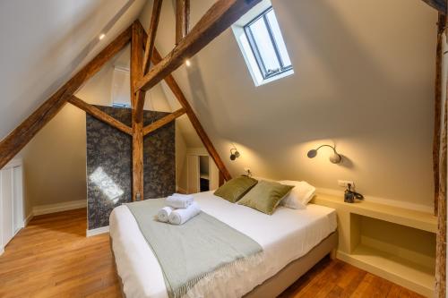 a bedroom with a large bed in a attic at Ty Mary-Ann - Duplex de 100 m² vue port in Vannes