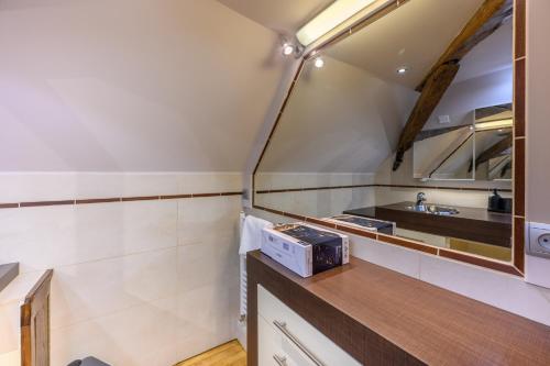 a small bathroom with a sink and a mirror at Ty Mary-Ann - Duplex de 100 m² vue port in Vannes