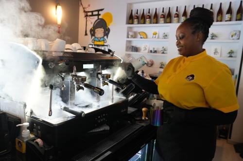 a woman cooking in a kitchen with smoke coming at AG Hotel in Abu Dhabi
