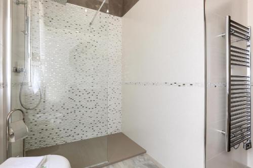 a white bathroom with a shower and a toilet at La Perla Bianca Luxury Spa by Perle di Puglia in Oria