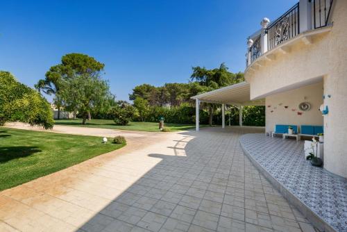 a patio in front of a building with a porch at La Perla Bianca Luxury Spa by Perle di Puglia in Oria