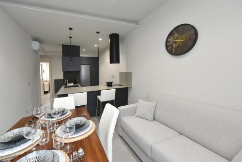 a living room with a white couch and a dining table at Belvedere Campanon in Nizza Monferrato