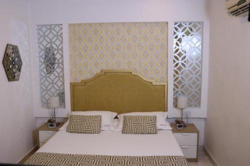 a bedroom with a large bed with two night stands at Gallery Hotel in Amman