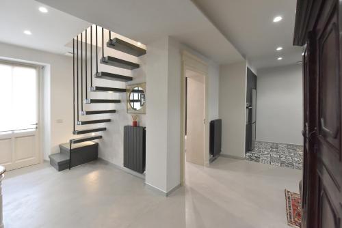 a hallway with a spiral staircase in a house at Belvedere Campanon in Nizza Monferrato