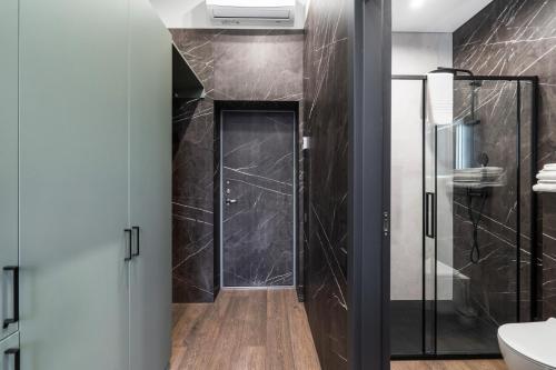 a bathroom with a walk in shower and a glass door at Apartments in Vilnius in Vilnius