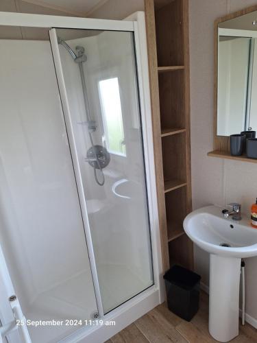 a bathroom with a shower and a sink at Lewis Sands PC114 in Lossiemouth