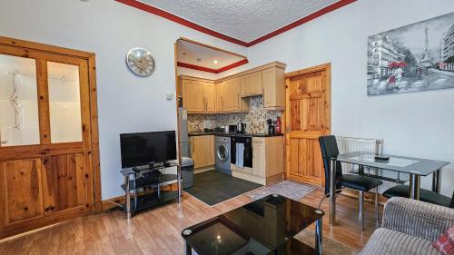 a living room with a table and a kitchen at Charming 1-Bedroom Home in Alexandria in Alexandria