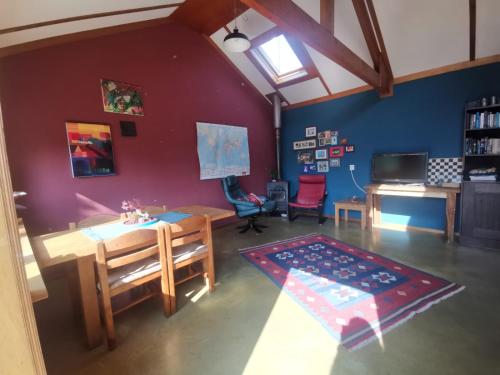 a living room with a table and a desk at Huisje Fiederels in Bant