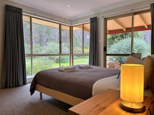 a bedroom with a bed and a large window at Mansfield Retreat - In Town - Margaret River in Margaret River Town