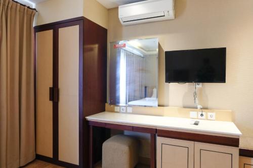 a bathroom with a sink and a mirror at Strategic and Comfy Studio at Grand Setiabudi Apartment By Travelio in Bandung