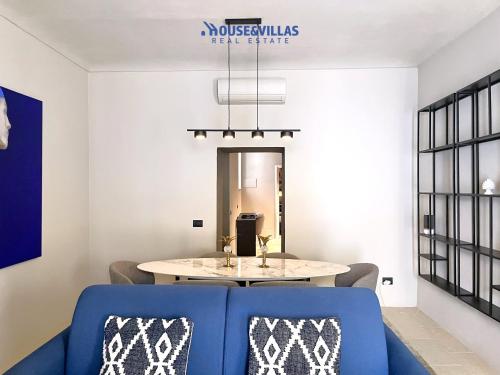 a dining room with a blue couch and a table at House&Villas - Casa Lelli in Noto