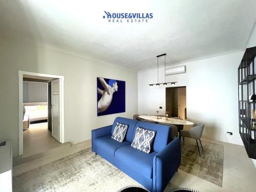 a living room with a blue couch and a table at House&Villas - Casa Lelli in Noto
