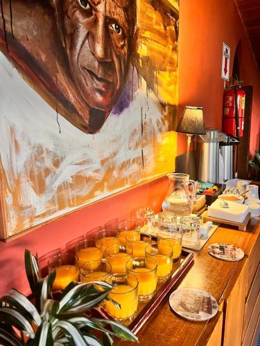 a tray filled with glasses of orange juice on a counter at Posada Del Fin Del Mundo in Ushuaia