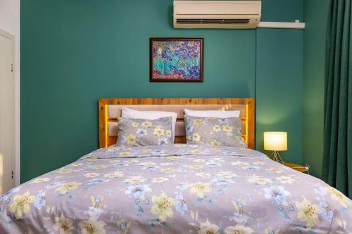 a bedroom with a bed with a blue wall at Casa Marincheshki in Orizari - 6км to Plovdiv in Orizari