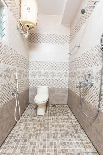 a bathroom with a toilet and a shower at SV RESIDENCY in Ooty