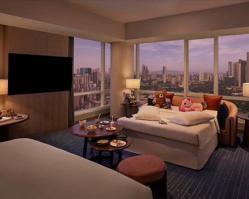 a hotel room with a bed and a large window at Four Seasons Hotel Mumbai in Mumbai