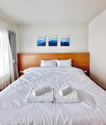 a large white bed with two white pillows on it at Pingchan Hotel Soidao in Ban Phra Trong