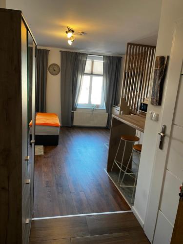 a room with a bedroom with a bed and a window at Pokoje Gościnne FABIO in Chojnice