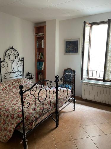 a bedroom with a bed and a book shelf at Casa Adriana in Pradalunga