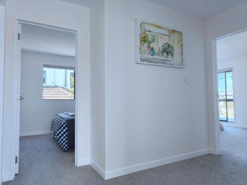 a room with a mirror and a painting on the wall at Stylish Family Retreat in Hillcrest 4 Bedroom and Playroom in Auckland