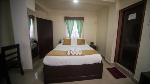 a bedroom with a bed with two towels on it at Ha Sharing in Shillong